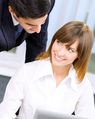 Businesspeople working with laptop at office