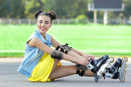 Young woman on roller skates in stadium