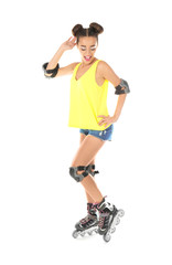 Beautiful young woman on roller skates against white background