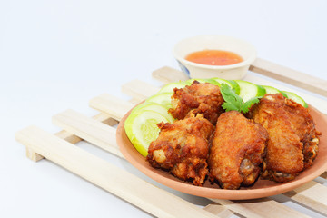 Fried chicken wings in batter with sauce