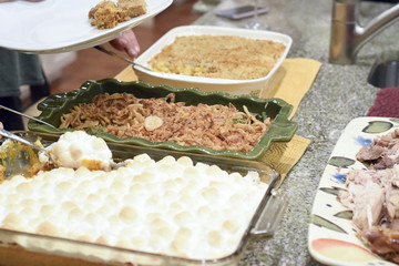 People serving themselves Thanksgiving dinner