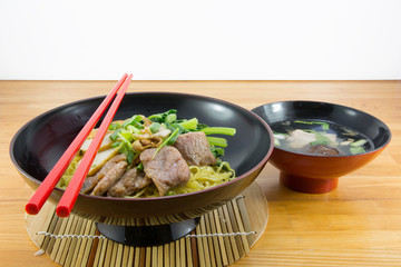 Noodle and red chopsticks on a table

