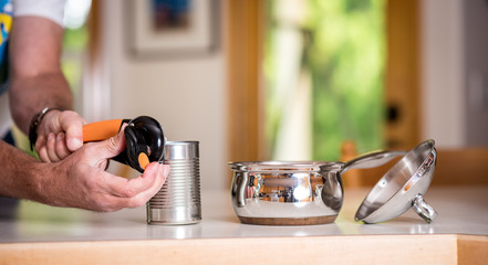 Using a can opener to unseal some beans