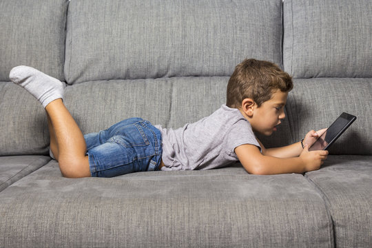 Little Boy Using A Tablet