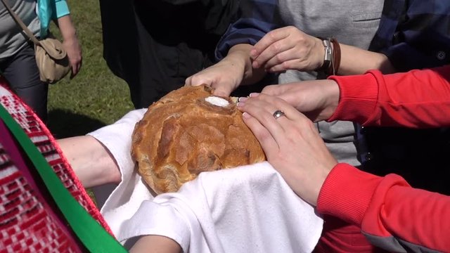 Kherson, Ukraine  - 14th of May, 2016: At "Green Farmstead of Entertainment" - Guests help themselves with bread