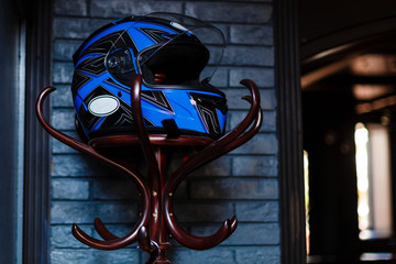 motorcycle helmet rests on a hanger