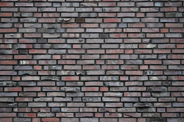 Grey grunge brick wall background, tiled. brick wall of dark stone texture