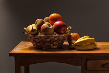basket of fruit on a wooden table
