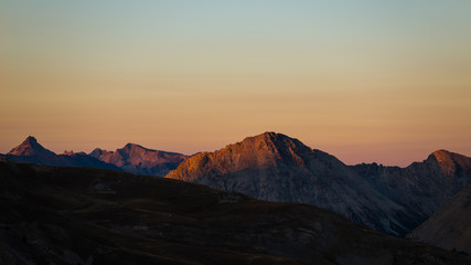 Fototapeta na wymiar Colorful sunlight on the majestic mountain peaks and ridges of the Alps.