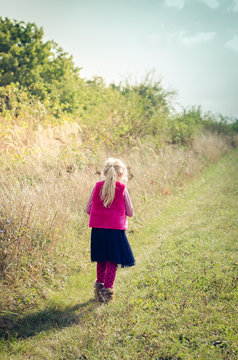 Child Walking Away In Rural Path