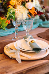 perfection, romance, design concept. tidy fltatware for celebration of wedding with knife and fork strapped of lilar thin ribbon, set of plates, two high aesthetic wineglasses