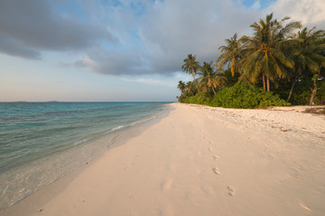 Tropical beach with footprints in the sand