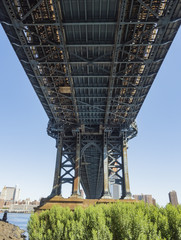 Under the Manhattan Bridge early in the morning with blue sky and sun shine - Brooklyn, New York, NY, United States of America, USA