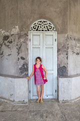 Fototapeta na wymiar Young girl in front of a old building