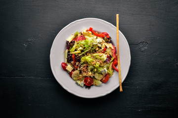 Salad of fresh vegetables and gorgonzola cheese. On a wooden background. Top view. Free space.