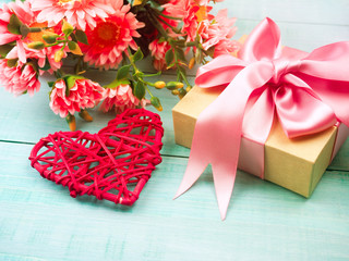 gift box and red wicker heart on a blue wooden background