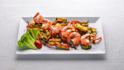Roasted Royal Prawns with Grilled Vegetables. On a wooden background. Top view. Free space.