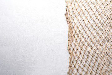 Fishing net made of wood On a wooden background. Top view. Free space.