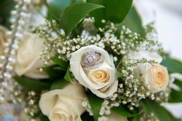 Beautiful white wedding bouquets in basket backgraound bouquet flowers rose / wedding rings