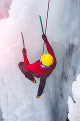 The climber climbs on ice.