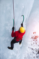 The climber climbs on ice.