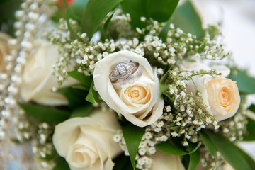 Beautiful white wedding bouquets in basket backgraound bouquet flowers rose / wedding rings