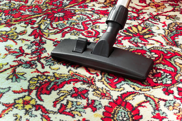 Cleaning dirty old carpet with a vacuum cleaner universal nozzle