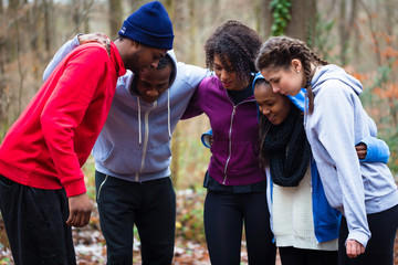 United and motivated young team preparing for an outdoors workout session
