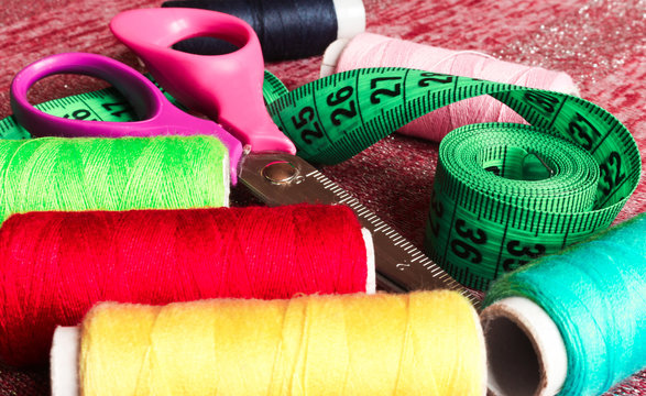 Sewing accessories. Thread , scissors, buttons, and tape measure seamstress.