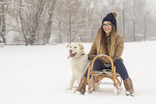 Woman and a dog in the snow