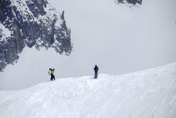 Fototapeta na wymiar Hikers on the snow at the Aiguille du Midi mountain, elevation 3.842m - Mont Blanc massif, Chamonix, French Alps, France, Europe.Ciaspolata - Chamonix Monte Bianco Francia