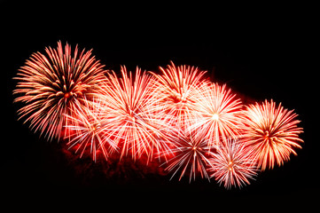 Red-white fireworks display on dark sky background