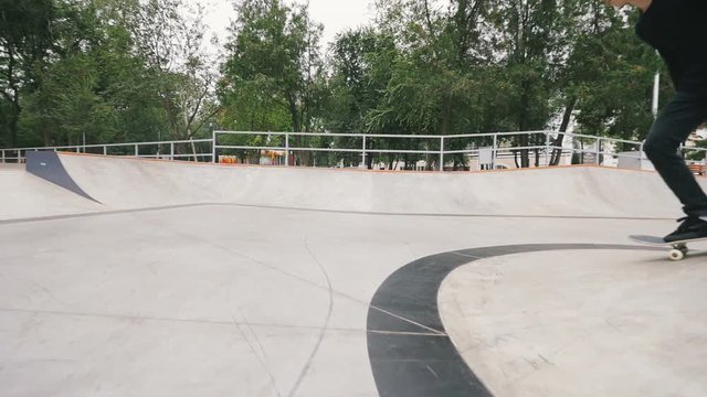 Skateboarder in skate park doing tricks, slow motion