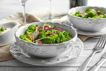 Dish with broccoli salad on table