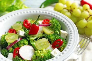 Dish with broccoli salad on table, closeup