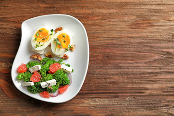 Plate with broccoli salad on table