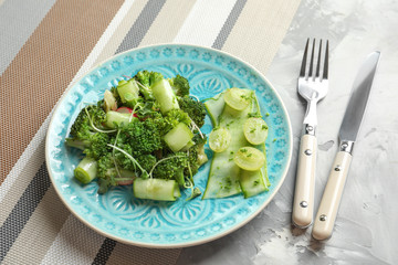 Plate with broccoli salad on table