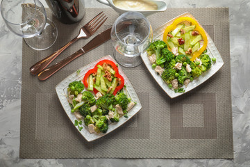 Plates with broccoli salad on table