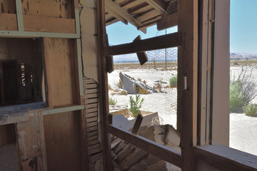 Ruined house in the desert. Broken window frame.