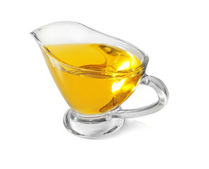 Glass gravy boat with cooking oil on white background