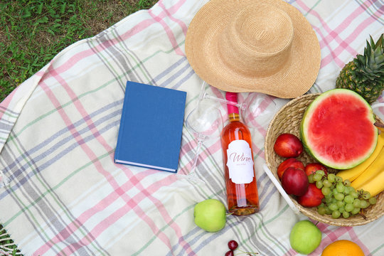 Composition with fruits and wine on picnic blanket