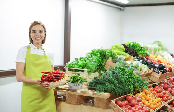 Young shop assistant working at market