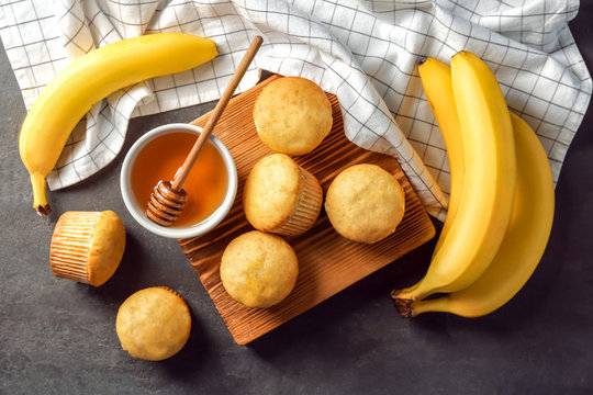 Composition with fresh banana muffins on table