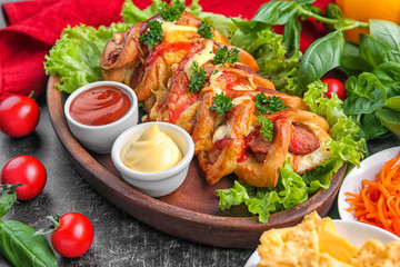 Tasty pastry with sausage on table