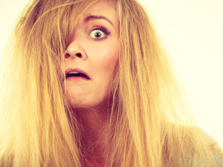 Naklejka premium Crazy, mad blonde woman with messy hair