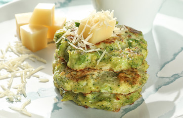 Delicious broccoli pancakes on plate, close up