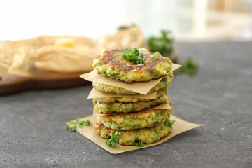 Delicious broccoli pancakes on table