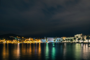 Fototapeta na wymiar Croatia. Evening panorama of the embankment of Split, with a multicolored reflection in the sea water