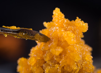 Cannabis concentrate live resin (extracted from medical marijuana) with a dabbing tool - 173321989