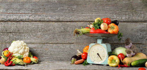 Fototapeta na wymiar Banner composition of raw organic fresh vegetables, balance on wooden brown table